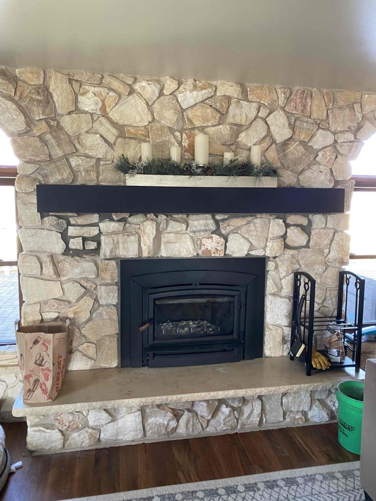 Original photo from The Fire Factory of a wood insert with a stone surround.
