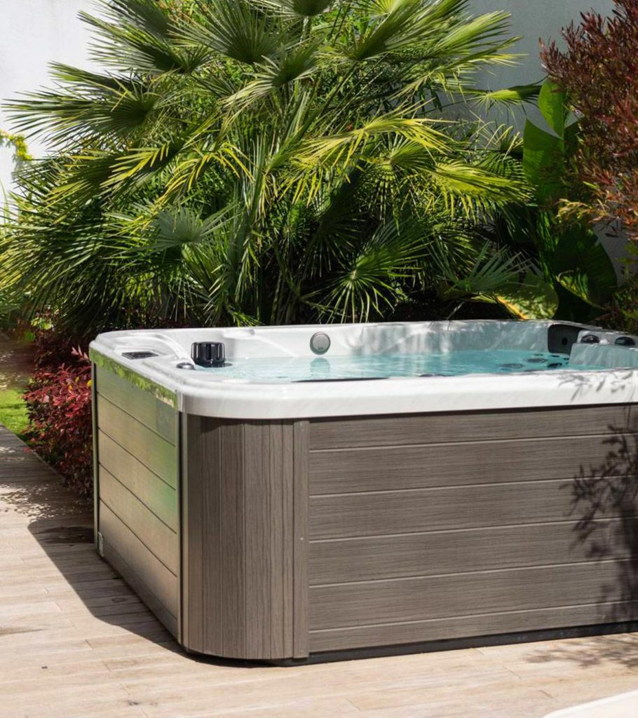 Original photo from The Fire Factory of an outdoor spa or hot tub by tropical plants.