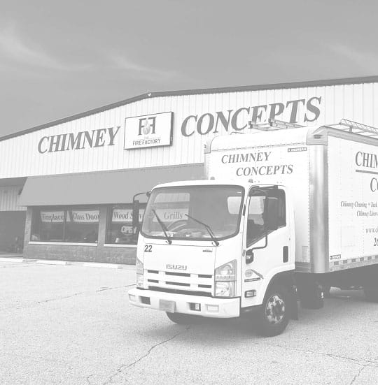 An original photo of the outside of The Chimney Concepts, with their service vans in front.